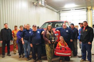 The Arden fire crew with Terry and Trent Gervais in front of the Henderson sub-station's new truck, bag of medical supplies, and defib unit on Tuesday night (November 24)